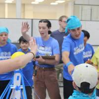 Blue team competes in Physics Olympics paper tower challenge